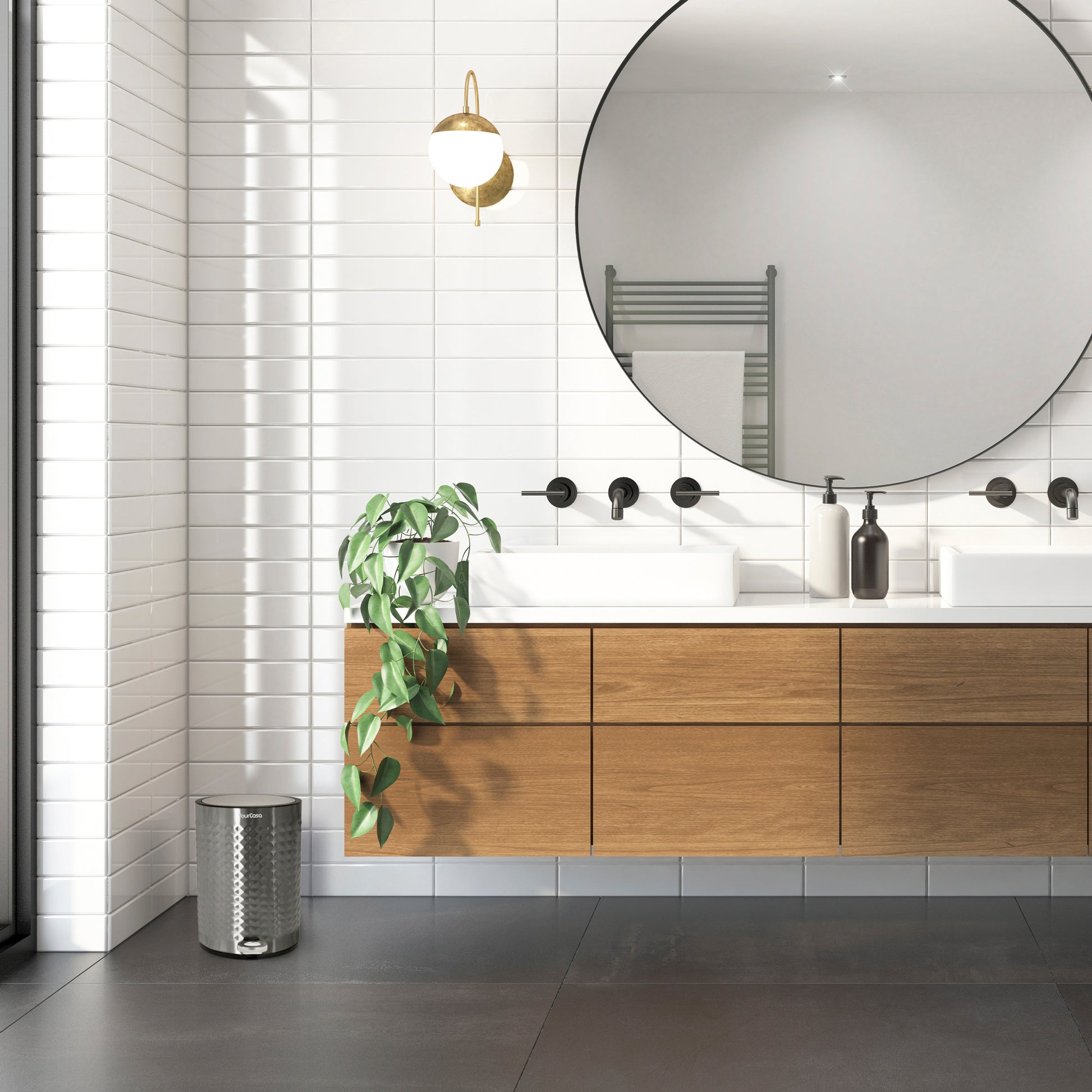 Ein modernes Badezimmer mit einem großen runden Spiegel, einem Waschtisch aus Holz, einer grünen Pflanze und einem YourCasa® Edelstahl-Mülleimer Bad 5L – Pyramiden-Oberflächenstruktur.