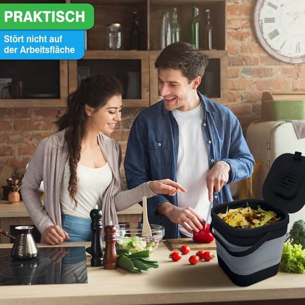 Mann und Frau bereiten Essen in einer Küche zu. Auf der Arbeitsplatte steht ein YourCasa® Komposteimer Küche – FALTBAR und NACHHALTIG – 4L Fassungsvermögen für Essensreste.